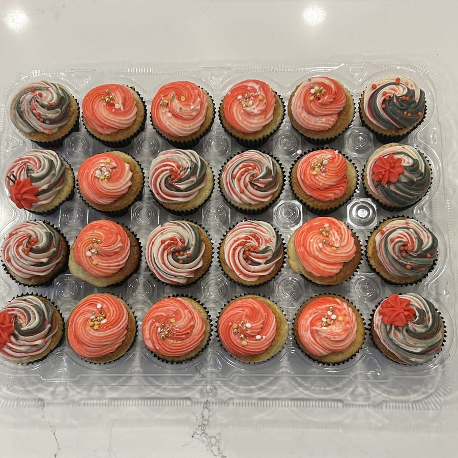 A dozen coral and rose swirled cupcakes