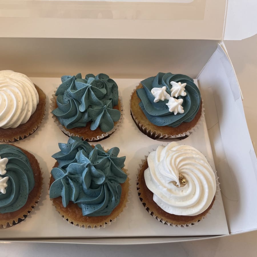 Slate-blue and white piped buttercream cupcakes